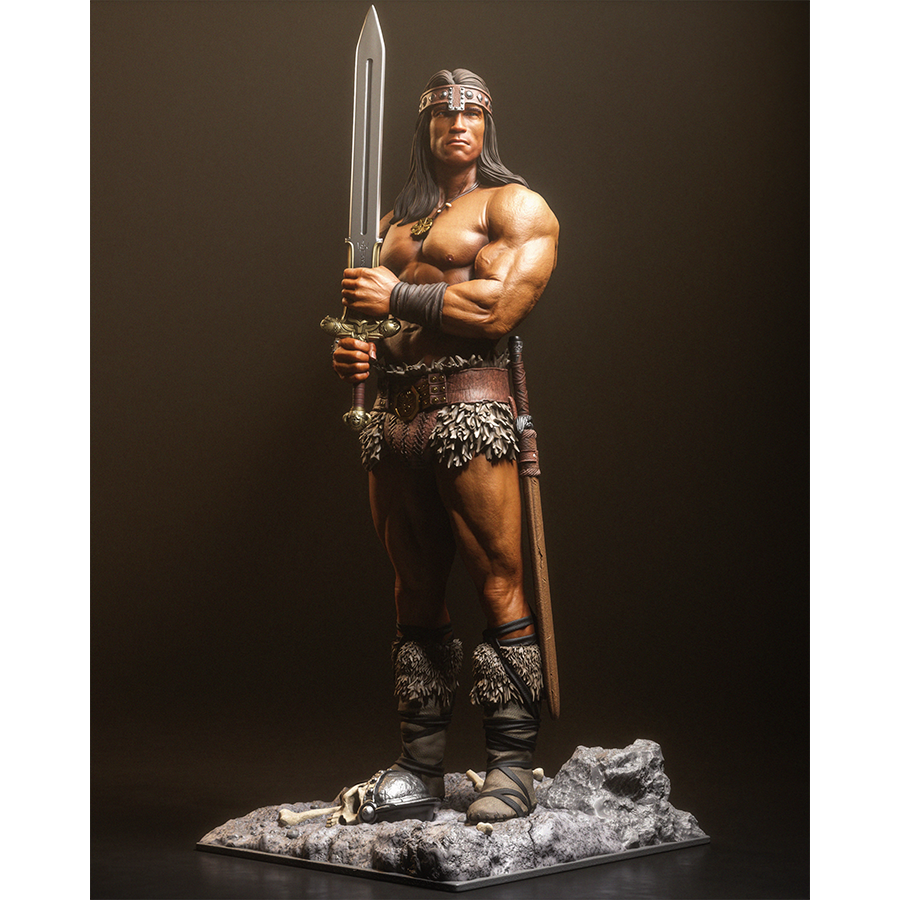 Resin figure of Conan the Barbarian holding a sword upright on a rocky base