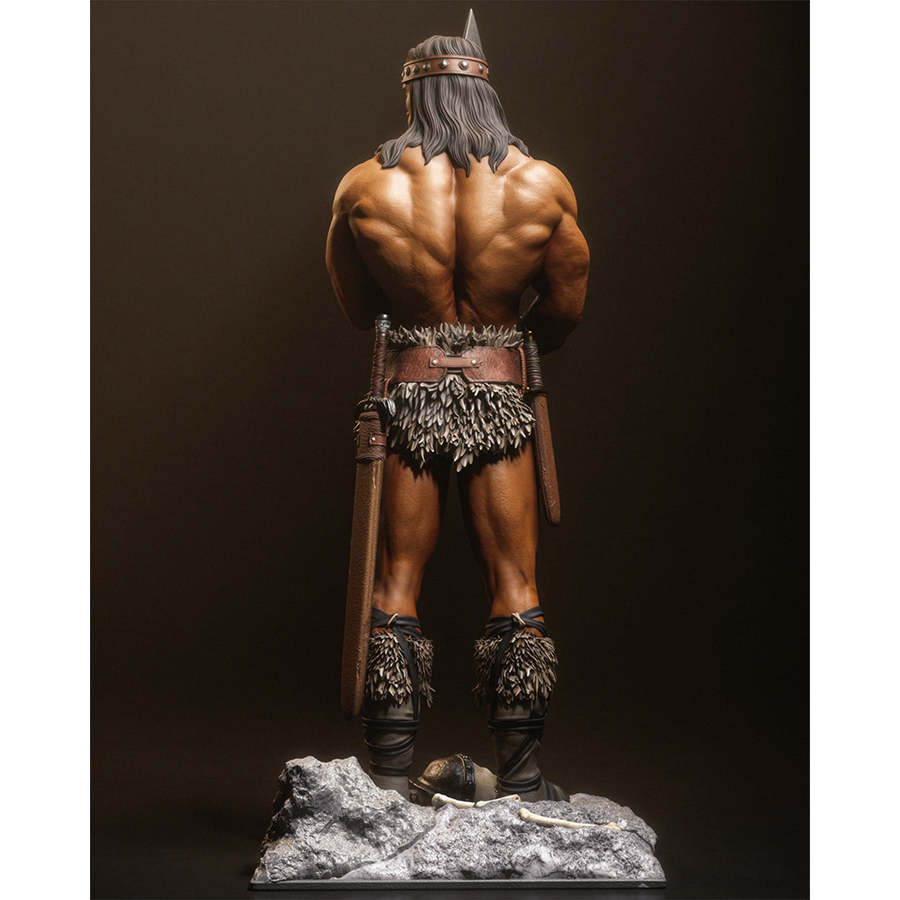 Resin figure of Conan the Barbarian holding a sword upright on a rocky base