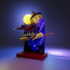 Bewitched resin figure printed by HLI3DFX, sculpted by UEL Winner, featuring a witch on a broom in front of a moonlit skyline backdrop with logo display base